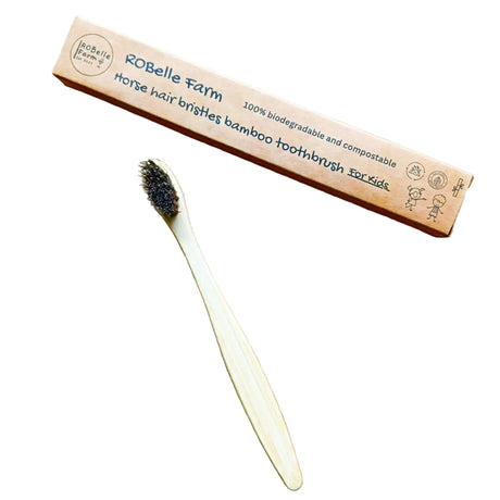 Robelle Farm bamboo toothbrush with horse hair bristles on a beige background